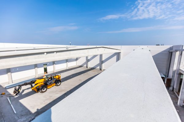 Roof construction on warehouse building site. Building a new industrial hall or storehouse